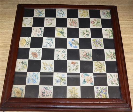 An early 20th century mahogany framed chess board, painted in watercolour with botanical studies of Swiss flowers overall 48cm sq.